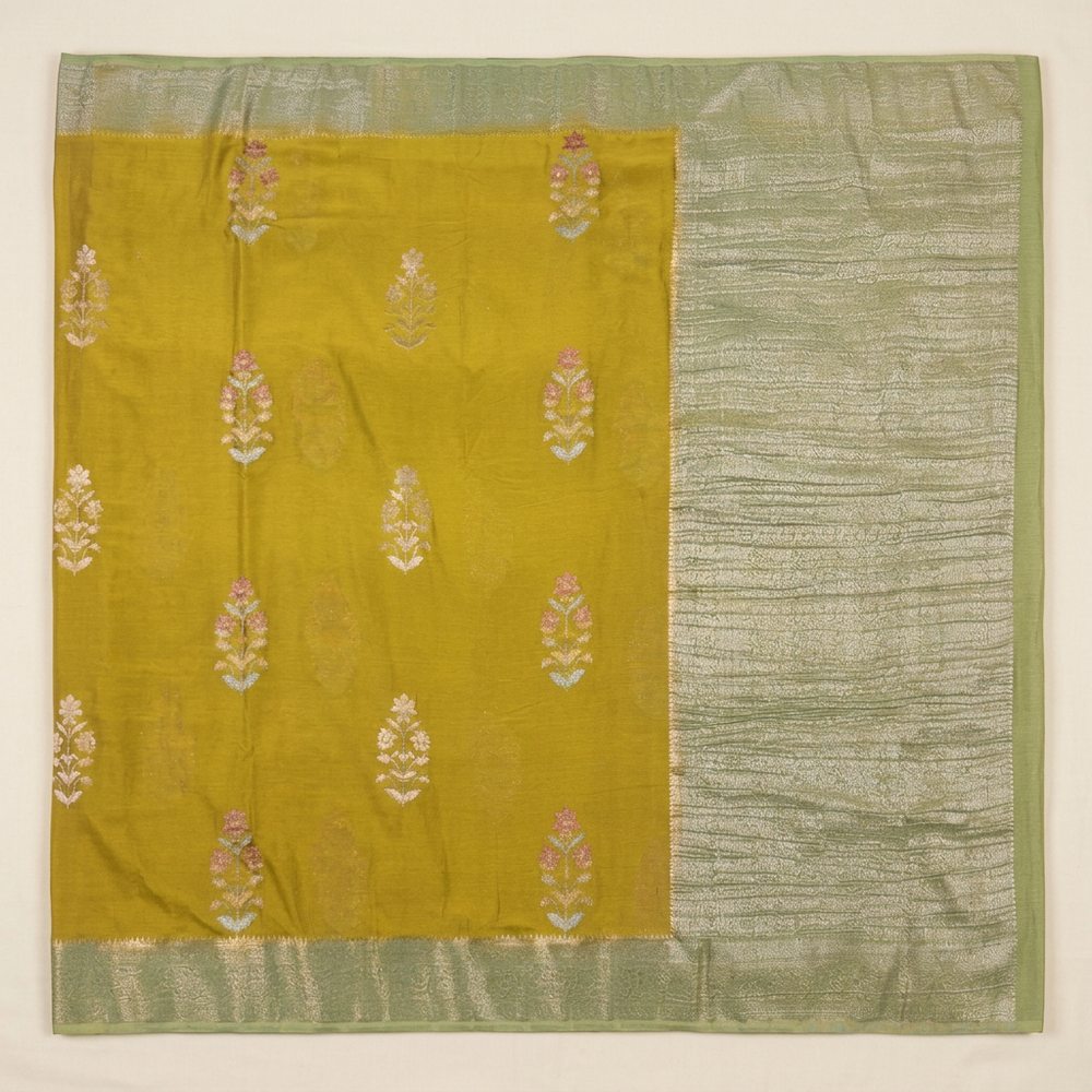 Upright green Khaddi georgette saree with yellow-green floral buta body and pale green metallic pallu