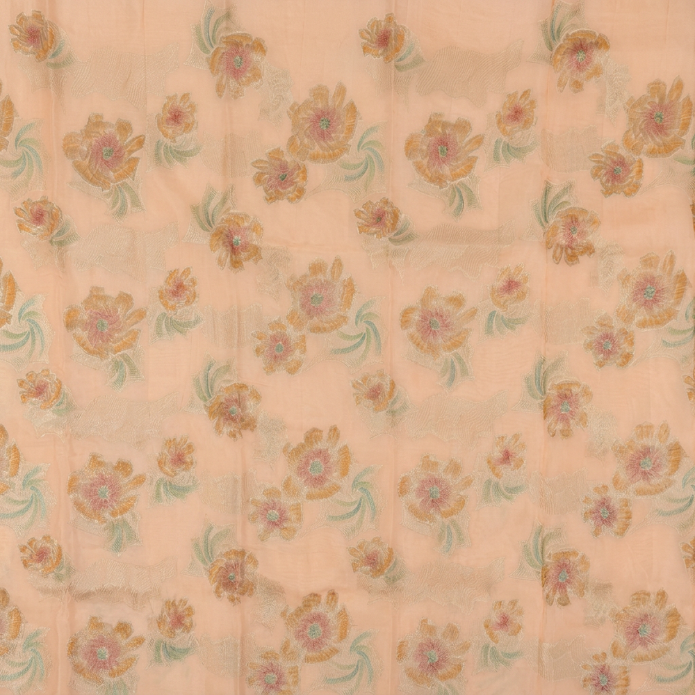 Close-up of peach pink chiffon body with gold-toned flowers and green accents