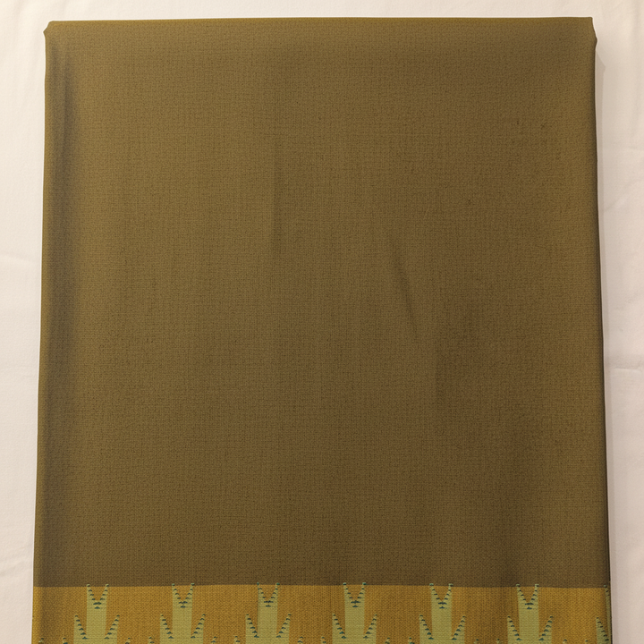 Close-up of the mehendi-green and muted mustard cotton saree showing its subtle woven texture and golden mustard motif panel