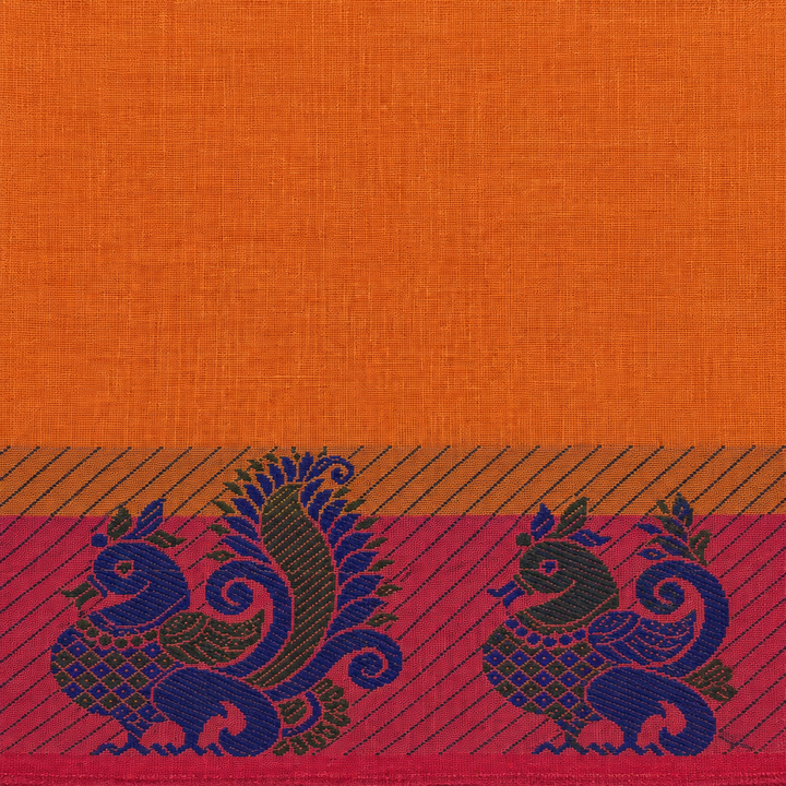 Close-up of orange cotton saree body and magenta border edge