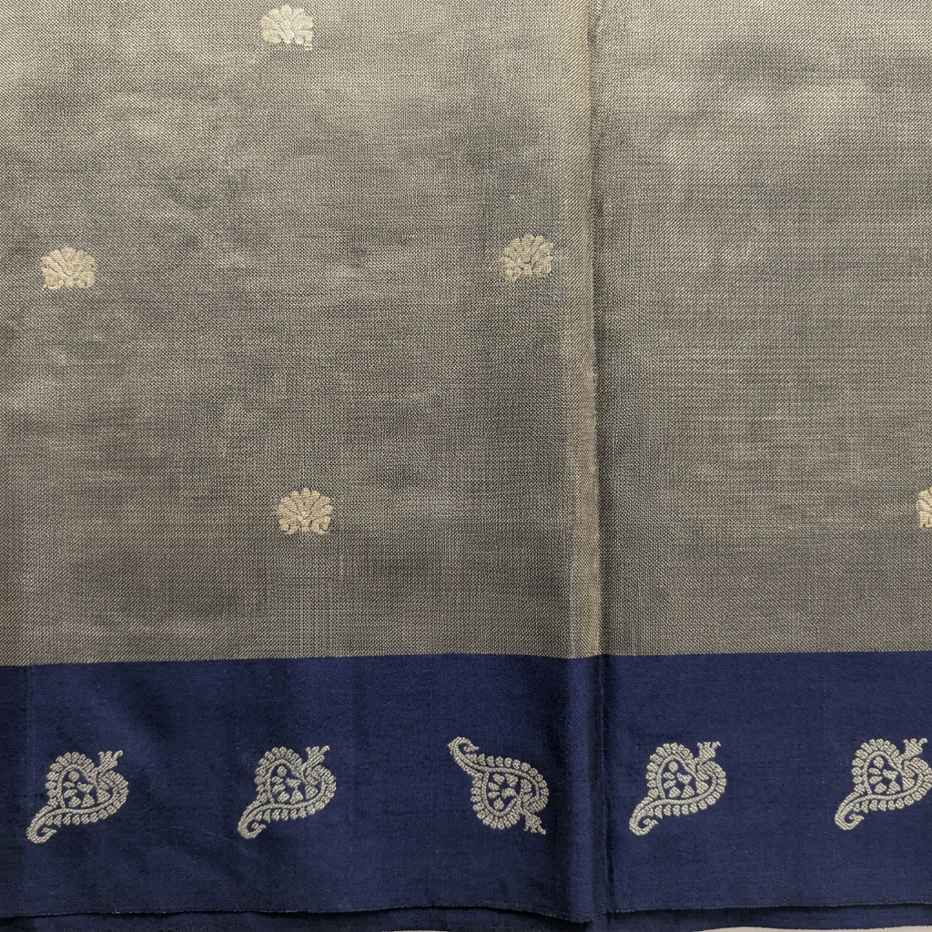 Close-up of metallic grey-gold pallu and navy paisley border on blue tissue Paithani saree