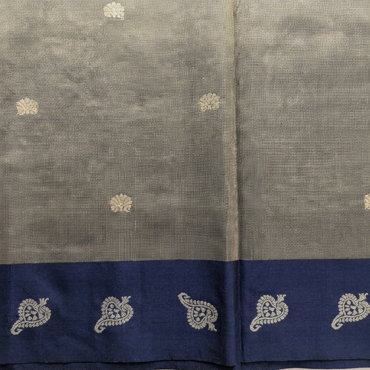 Close-up of metallic grey-gold pallu and navy paisley border on blue tissue Paithani saree