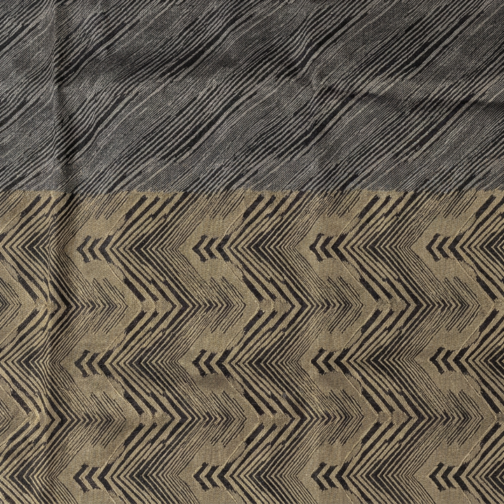 Close-up of black diagonal lines and gold-toned chevron design