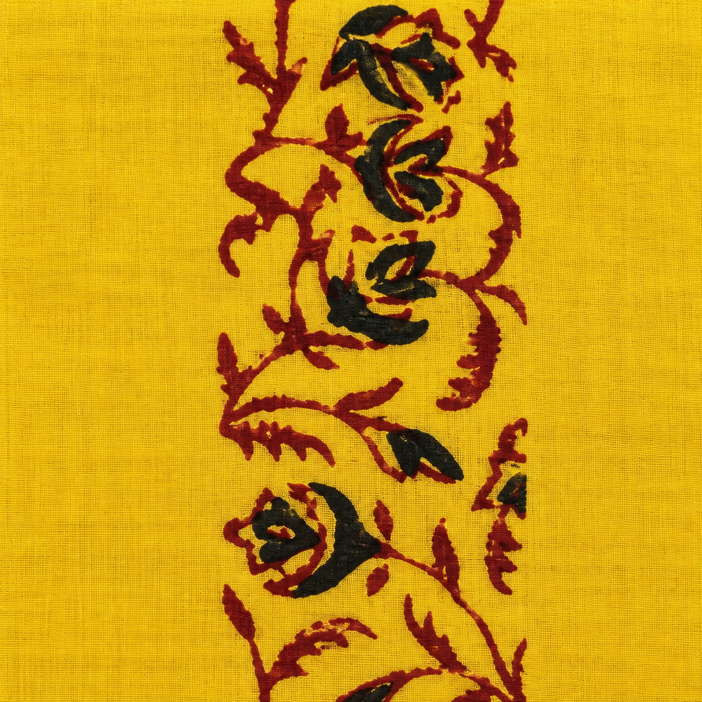 Close-up of black and maroon rose vine print on yellow cotton saree