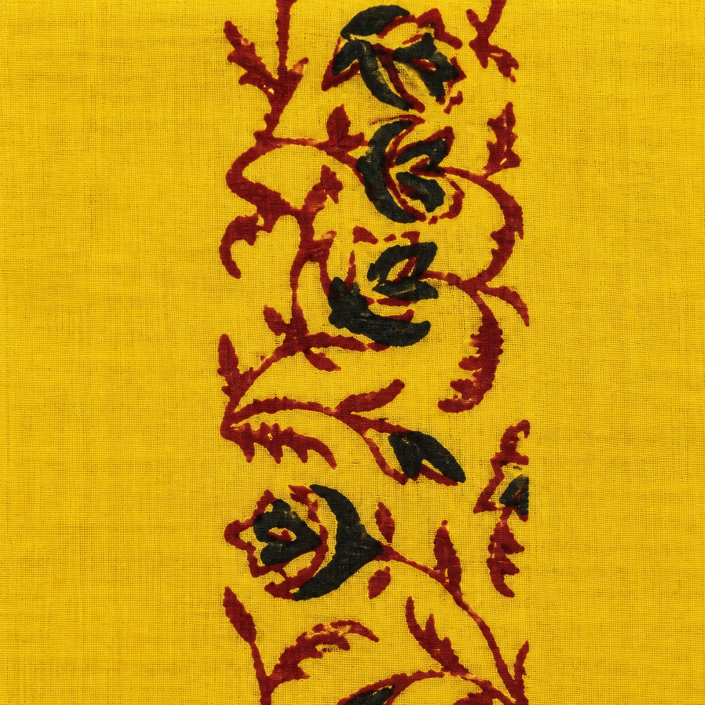 Close-up of black and maroon rose vine print on yellow cotton saree