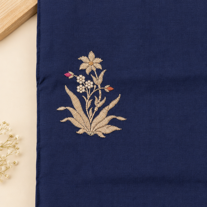 Close-up of gold floral motif on navy blue saree