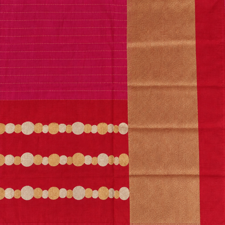 Close-up of red saree circle motifs and textured gold-toned pallu panel