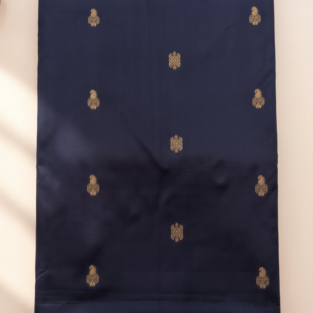 Ink-blue pure silk saree body with gold zari motifs close-up