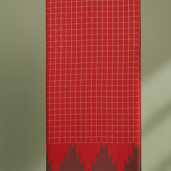 Close-up of the vivid red and scarlet cotton saree with its fine pale-gold checked grid