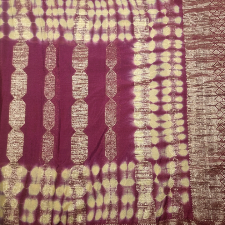 Close-up of purple saree body with cream dotted bands and elongated linked metallic motifs
