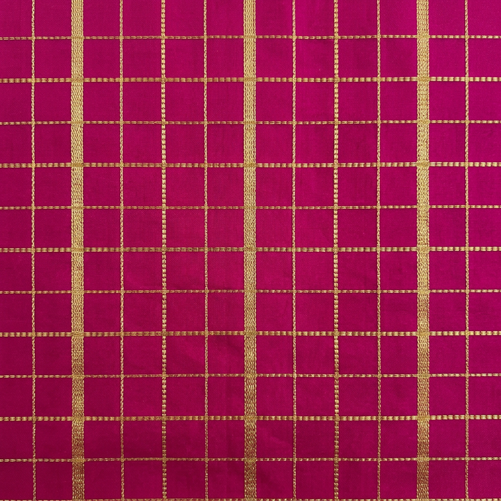 Close-up of the magenta pink saree section with gold zari checked grid pattern
