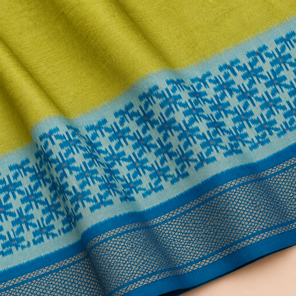 Close-up of parrot green and blue Pochampally silk saree texture, contrast pallu and border