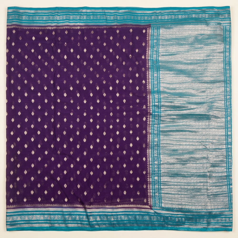 Upright purple and blue Khaddi georgette saree with small metallic motifs, turquoise borders and silver-toned pallu