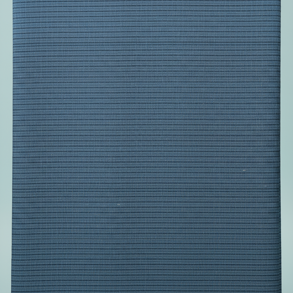 Close-up of the steel-blue and slate-blue cotton saree showing its fine horizontal striated weave and subtle tonal bands