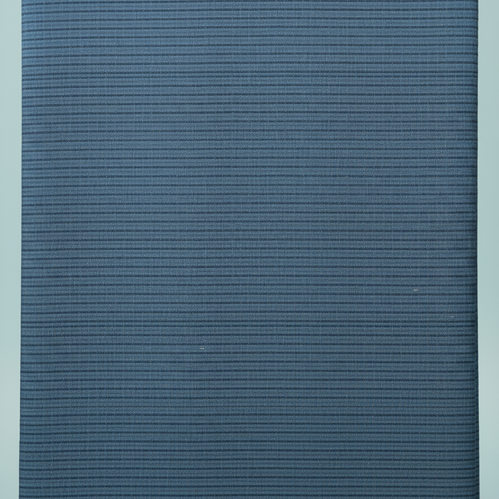 Close-up of the steel-blue and slate-blue cotton saree showing its fine horizontal striated weave and subtle tonal bands