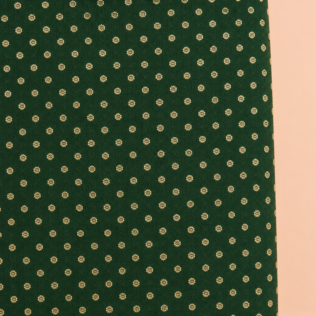 Close-up of the green saree body with small gold-tone motifs