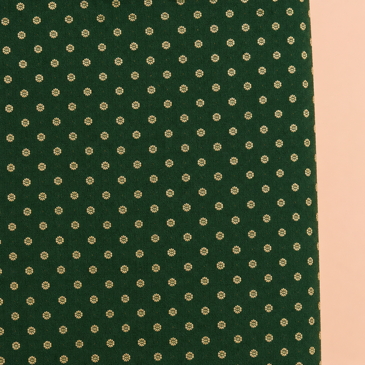 Close-up of the green saree body with small gold-tone motifs