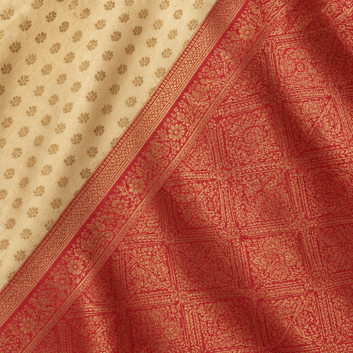 Close-up of the yellow saree's wide red woven zari border and patterned pallu