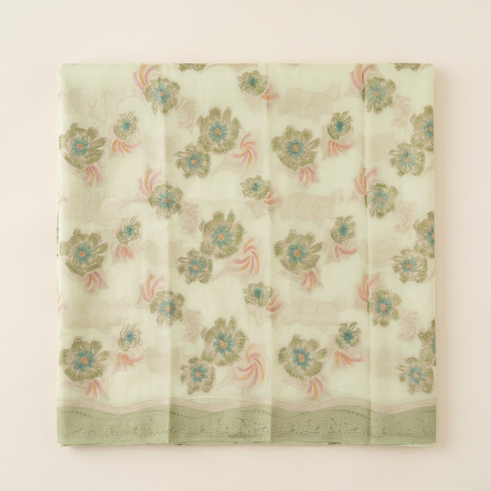 Straight overhead tight-fold pista green chiffon saree with muted floral design and green border