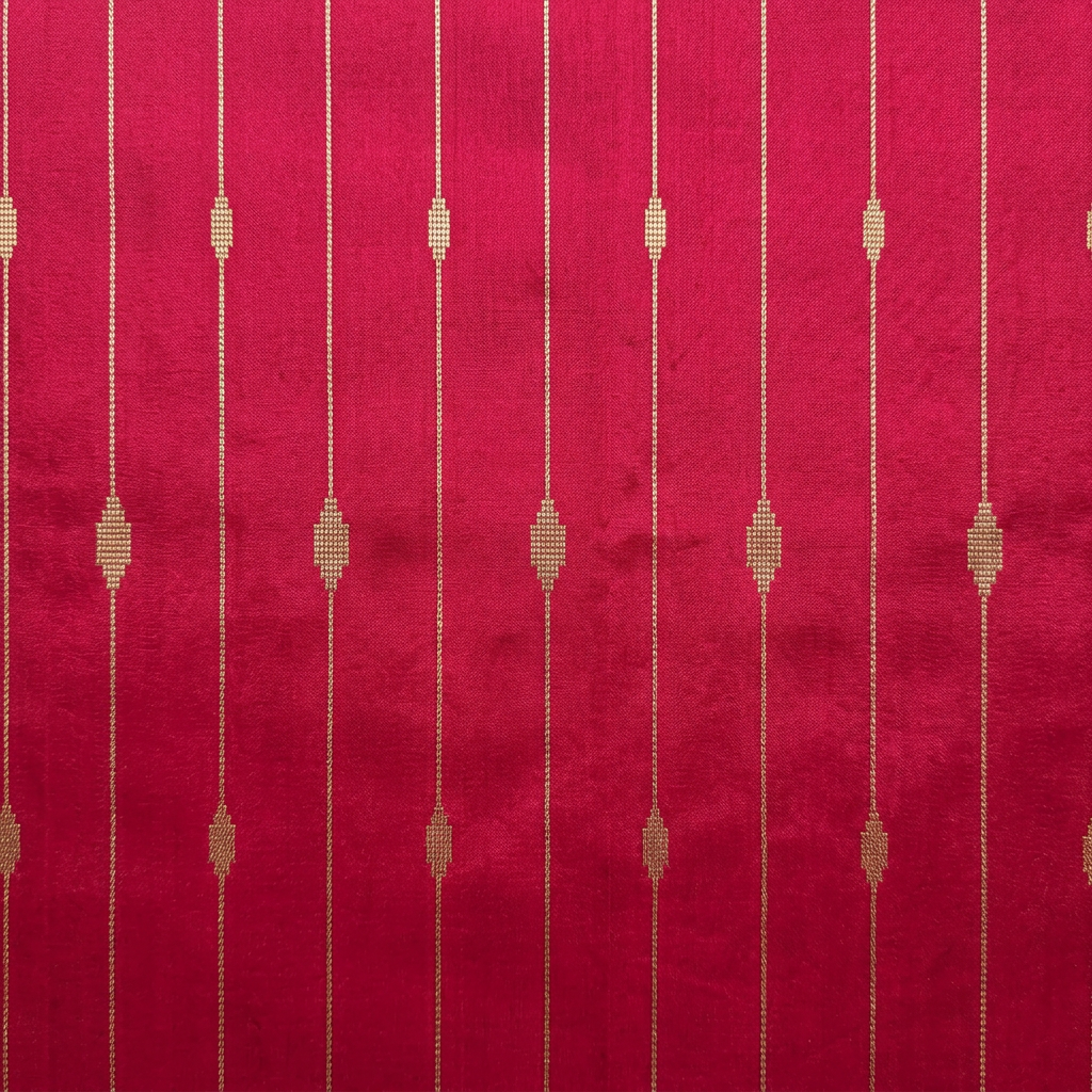Close-up of fine metallic-toned vertical lines and geometric motifs on pink silk
