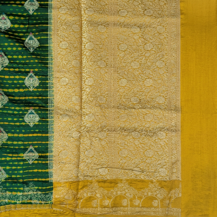 Close-up of gold-toned floral pallu and mustard yellow end