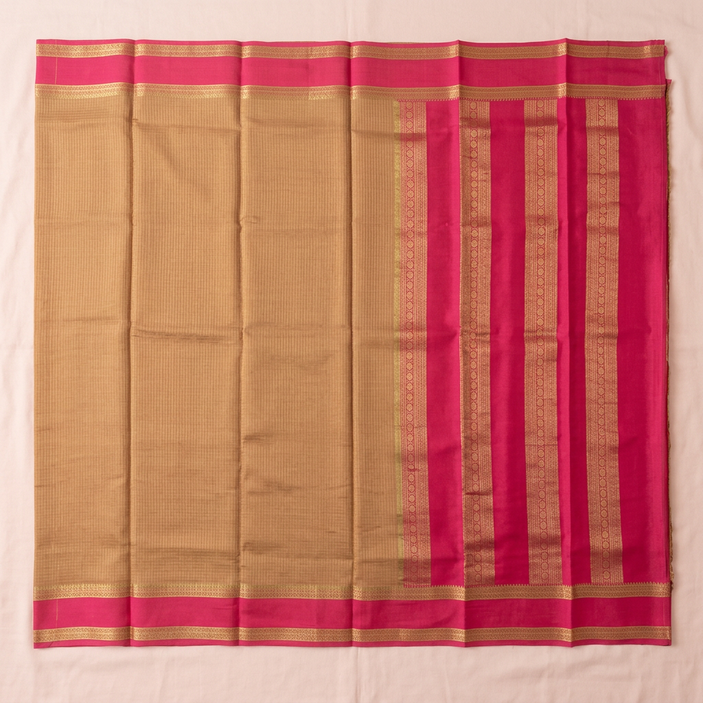 Upstraight overhead view of a pale brown and rani pink pure Mysore crepe silk saree with gold zari bands and pink gold-striped borders