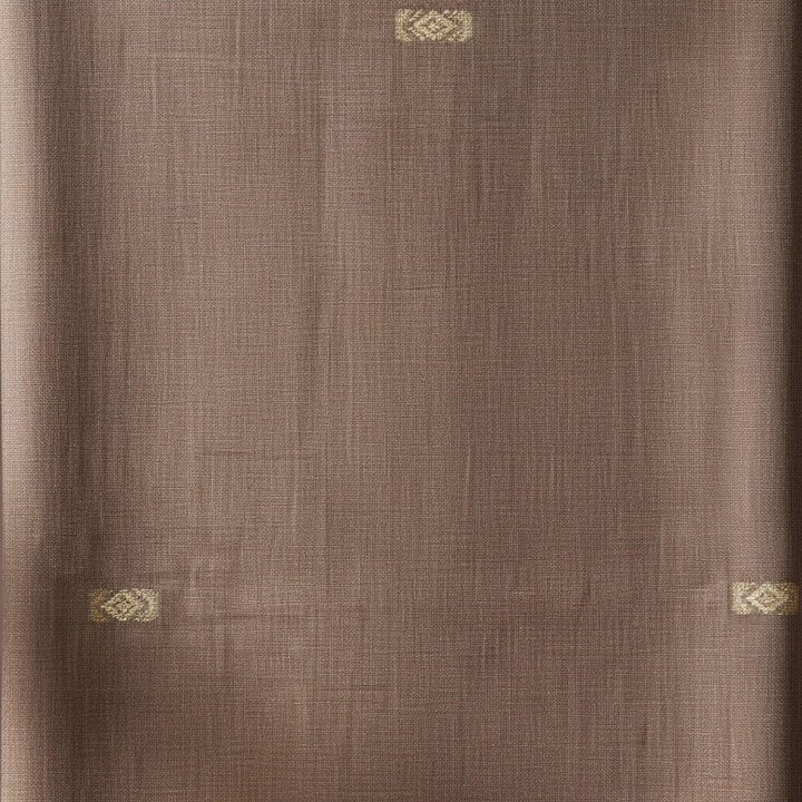 Close-up of the pale brown and taupe cotton saree showing its fine woven texture and scattered small antique-gold motifs