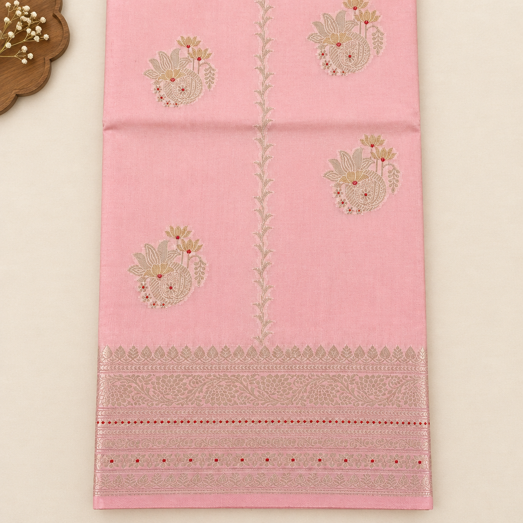 Close-up of floral motifs on baby pink Tussar silk saree