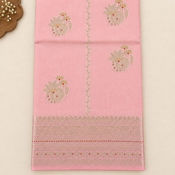 Close-up of floral motifs on baby pink Tussar silk saree