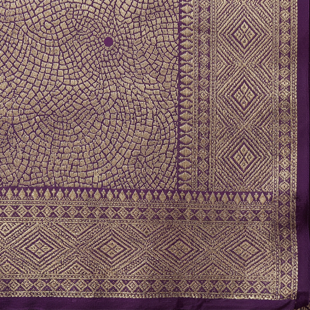 Close-up of purple and gold-toned diamond border and circular body pattern