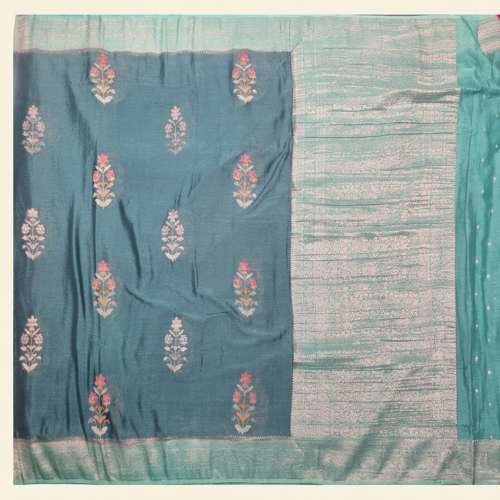 Upright blue Khaddi georgette saree with pink floral buta and pale metallic pallu