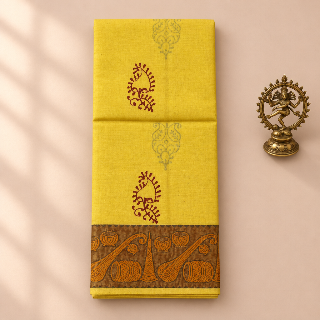 Lemon yellow cotton dance saree with musical instrument border, folded flat lay with Nataraja prop
