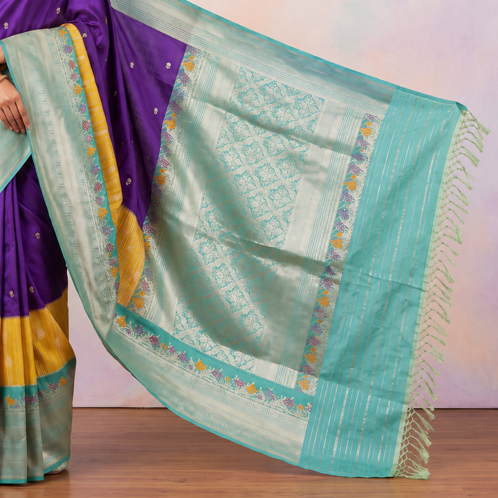 Aqua-blue saree pallu with silver-toned decorative panels, multicoloured floral accents and tasseled end