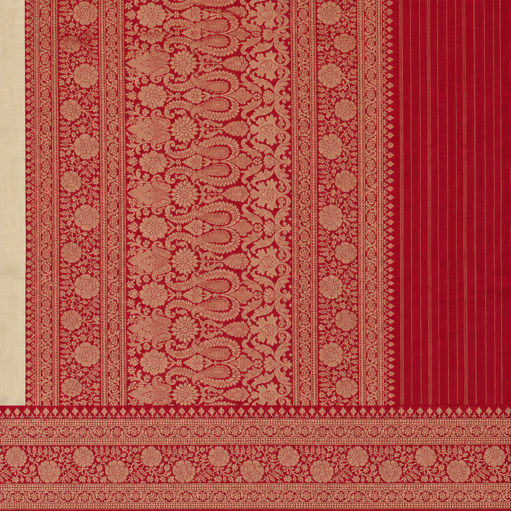 Close-up of red and gold-toned patterned saree border and pallu