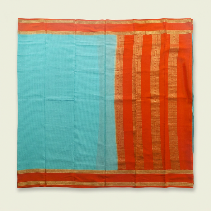 Upstraight overhead view of a turquoise blue and orange-red pure Mysore crepe silk saree with gold zari bands and orange-red gold-striped borders