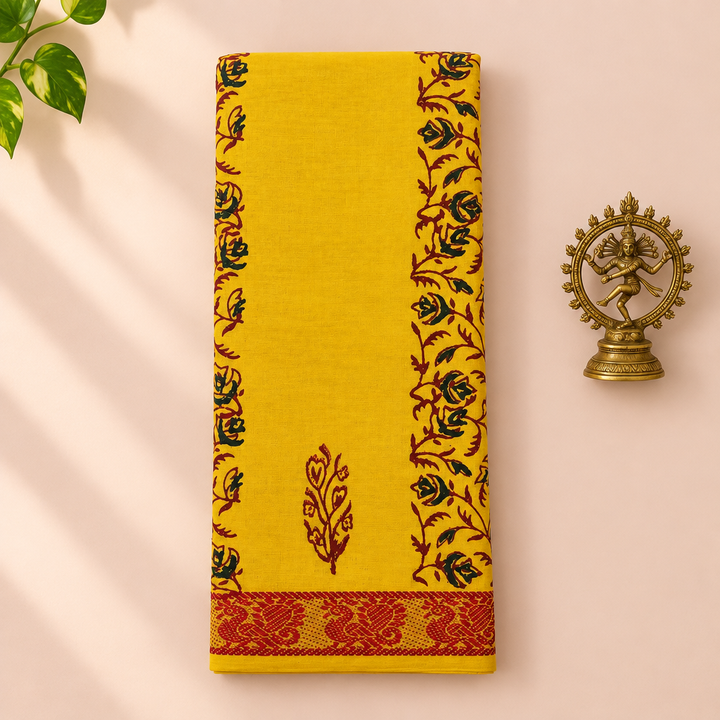 Yellow cotton dance saree with rose vine print and maroon border, folded flat lay with Nataraja prop