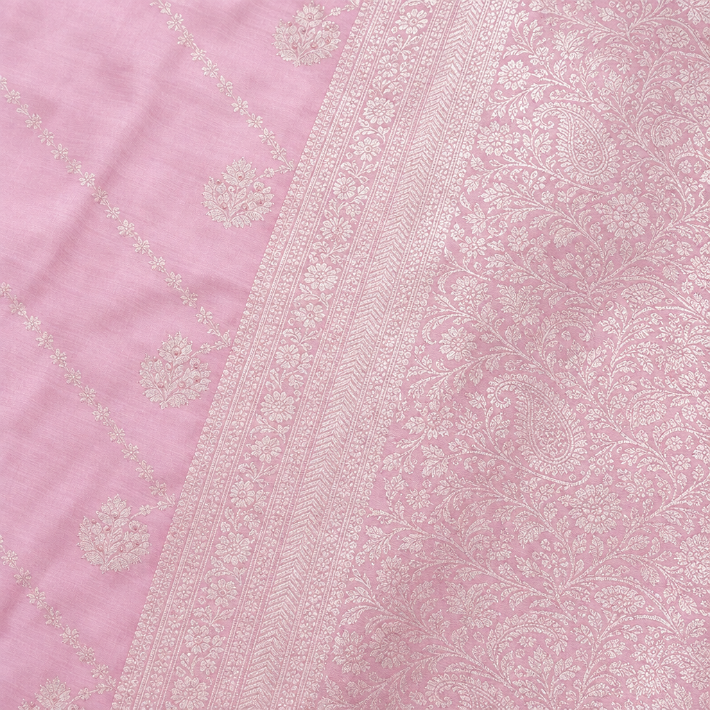 Close-up of the baby pink saree's woven silver zari border and patterned pallu
