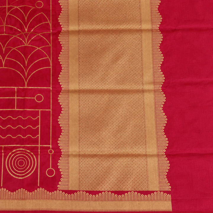 Close-up of red saree's textured gold-toned pallu panel and scalloped edging