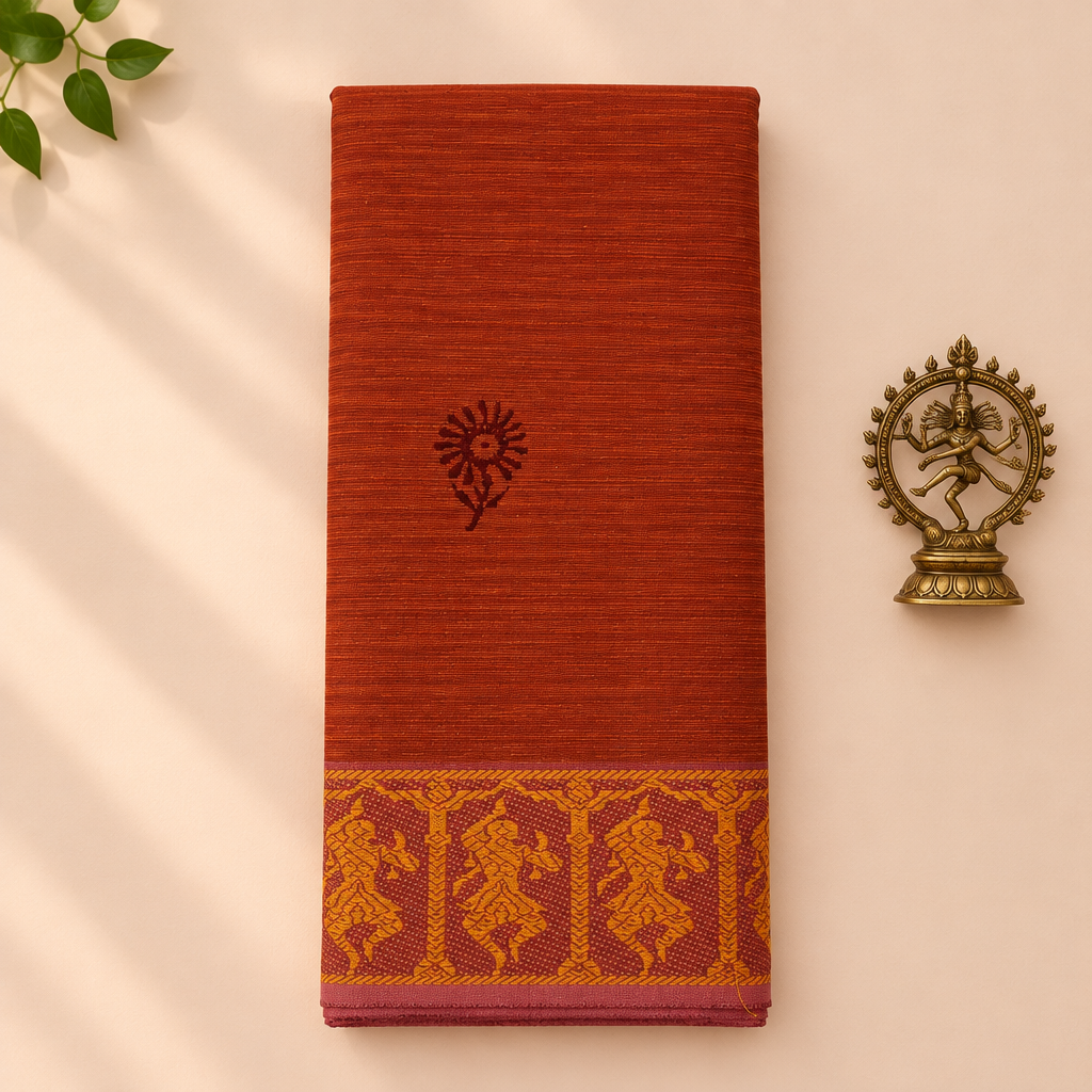Rust orange cotton dance saree with dancer border, folded flat lay with Nataraja prop