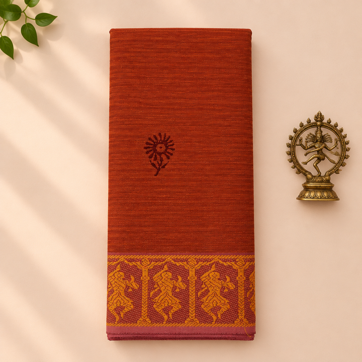 Rust orange cotton dance saree with dancer border, folded flat lay with Nataraja prop