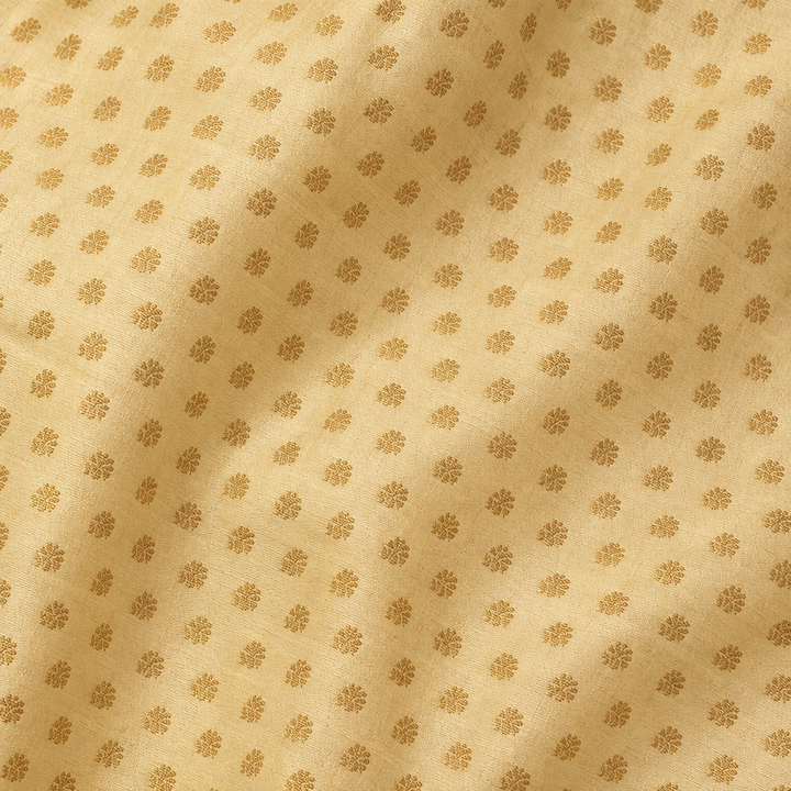 Close-up of the yellow pure Tussar silk saree body with gold dot motifs
