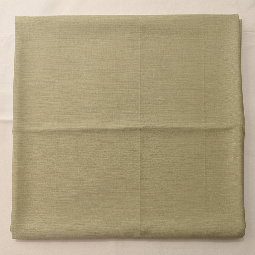 Close-up of the pale pista-green and light olive-grey cotton saree showing its subtle woven texture