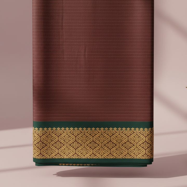 Close-up of the burgundy saree with its deep forest-green border, ornate antique-gold geometric lattice, and deep green lower edge