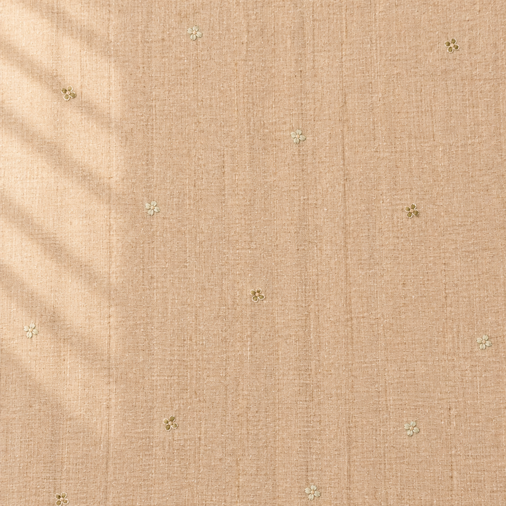 Close-up of the beige pure Tussar silk saree body showing woven texture and tiny floral butti motifs