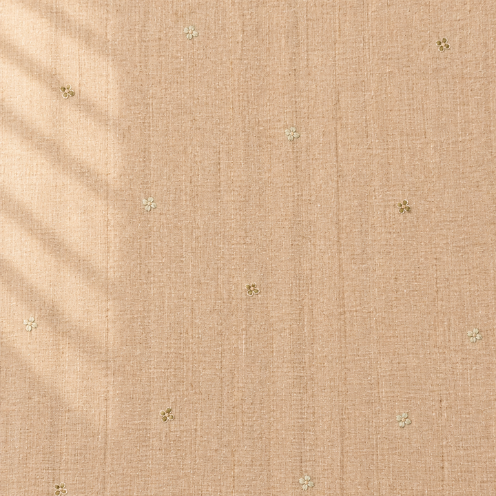 Close-up of the beige pure Tussar silk saree body showing woven texture and tiny floral butti motifs