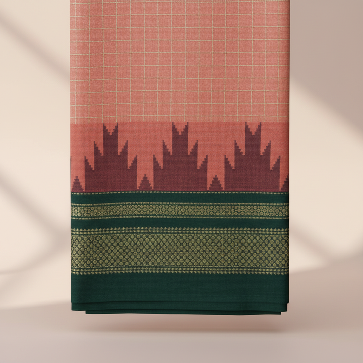 Close-up of the peach-coral saree with its dark maroon-purple jagged motif band and deep green border with intricate gold-green woven detailing