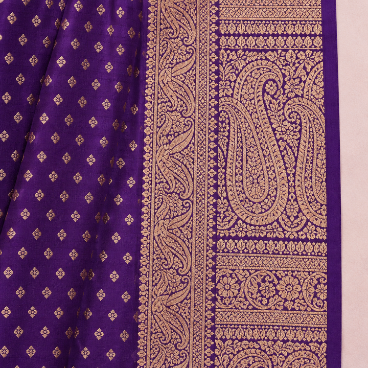 Close-up of the gold-toned patterned border and pallu beside the purple saree body