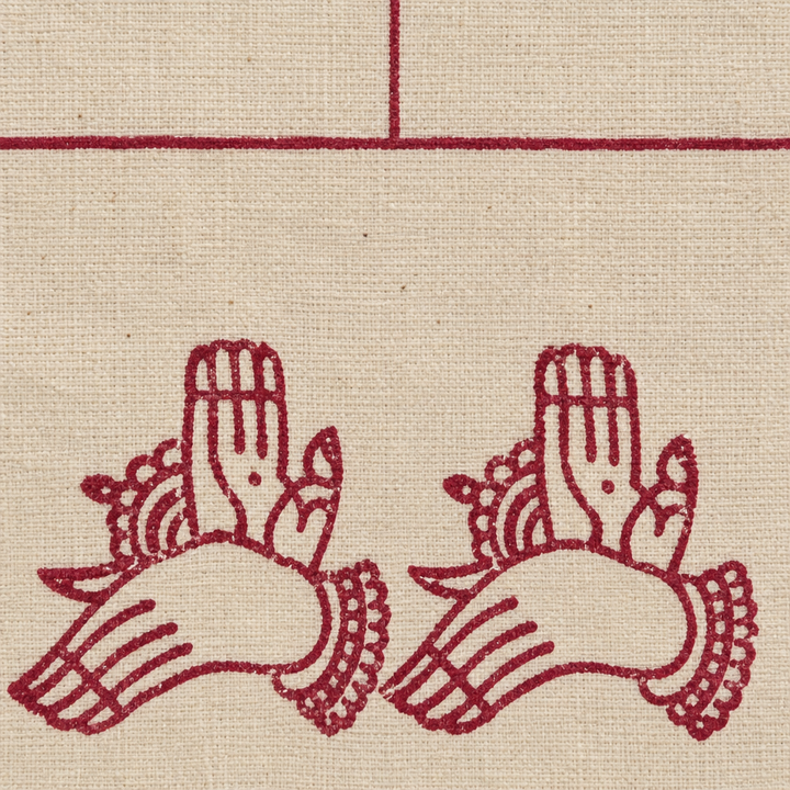 Close-up of maroon hand-mudra print border on cream cotton dance saree