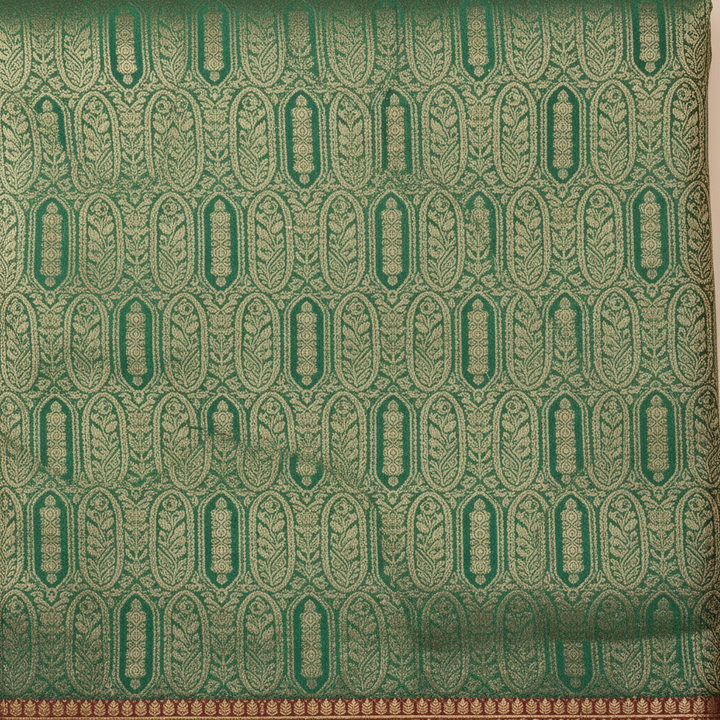 Close-up of green semi-silk saree with repeating gold zari motifs