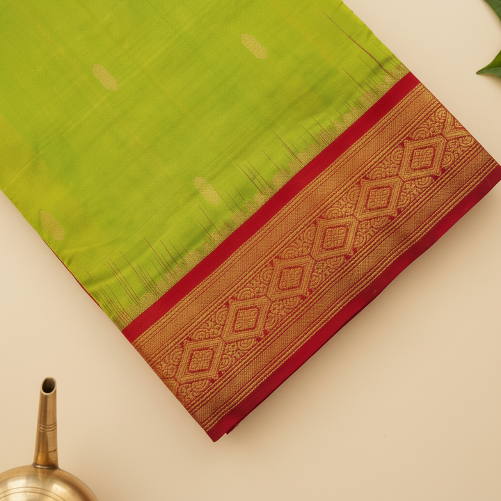 Red contrast zari border on a parrot-green 9-yard pure silk saree close-up